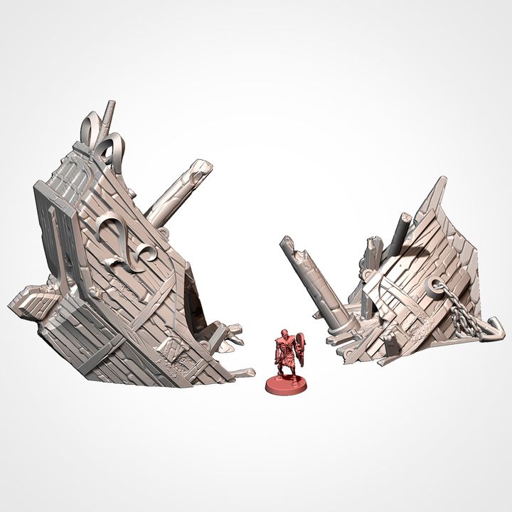 Broken bow and stern wrecks, shown beside a 32mm miniature for scale